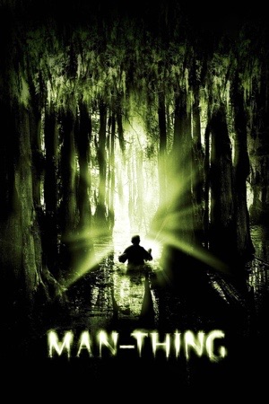 A small figure in a boat on a green swamp, sunlight cutting between hanging trees.